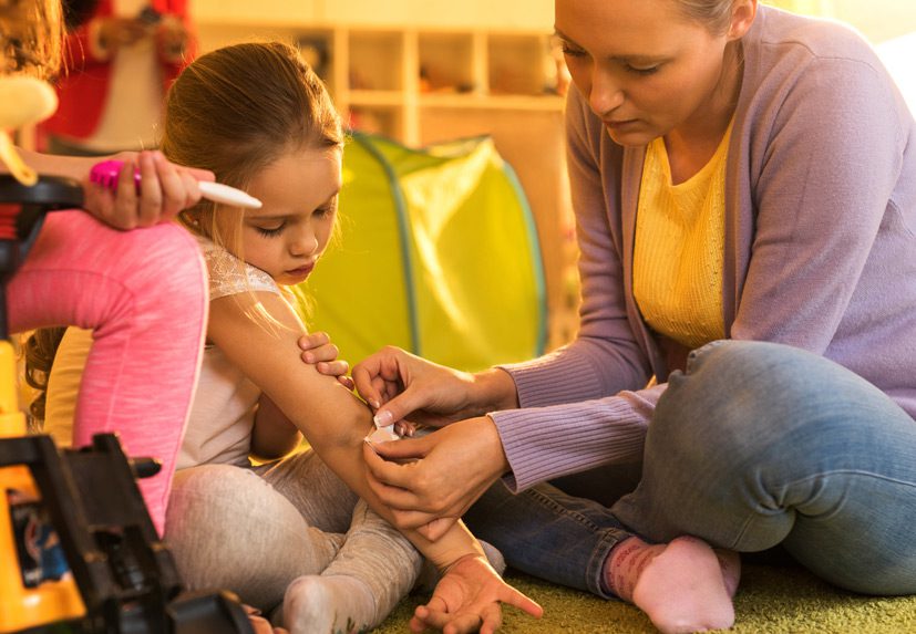 Child-receiving-a-bandaid-for-daycare-injury