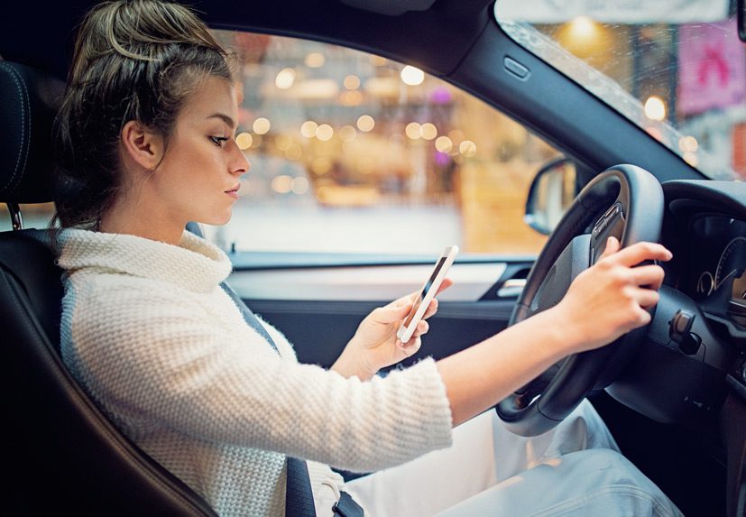 Woman-texting-and-driving-is-a-traffic-violation