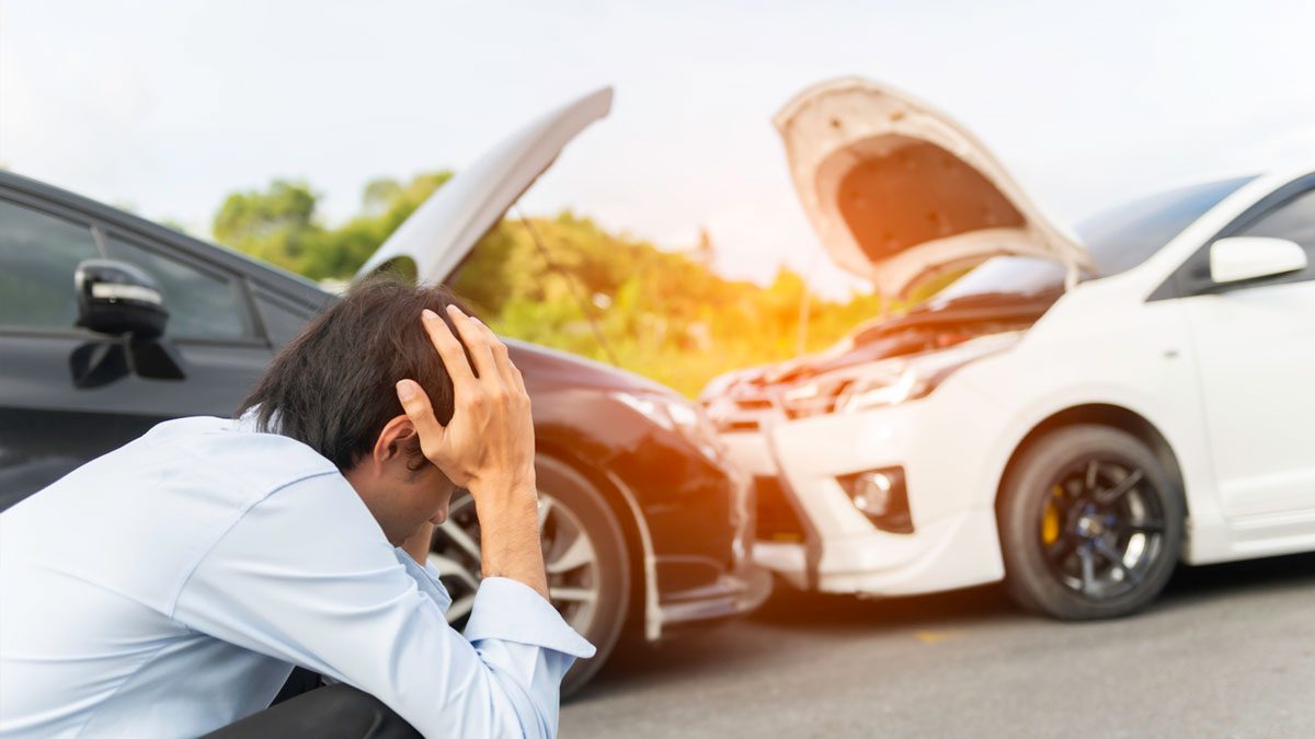 A worried male near damaged car after a car accident