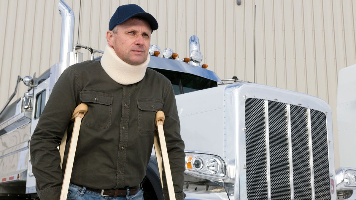 An injured truck driver on crutches