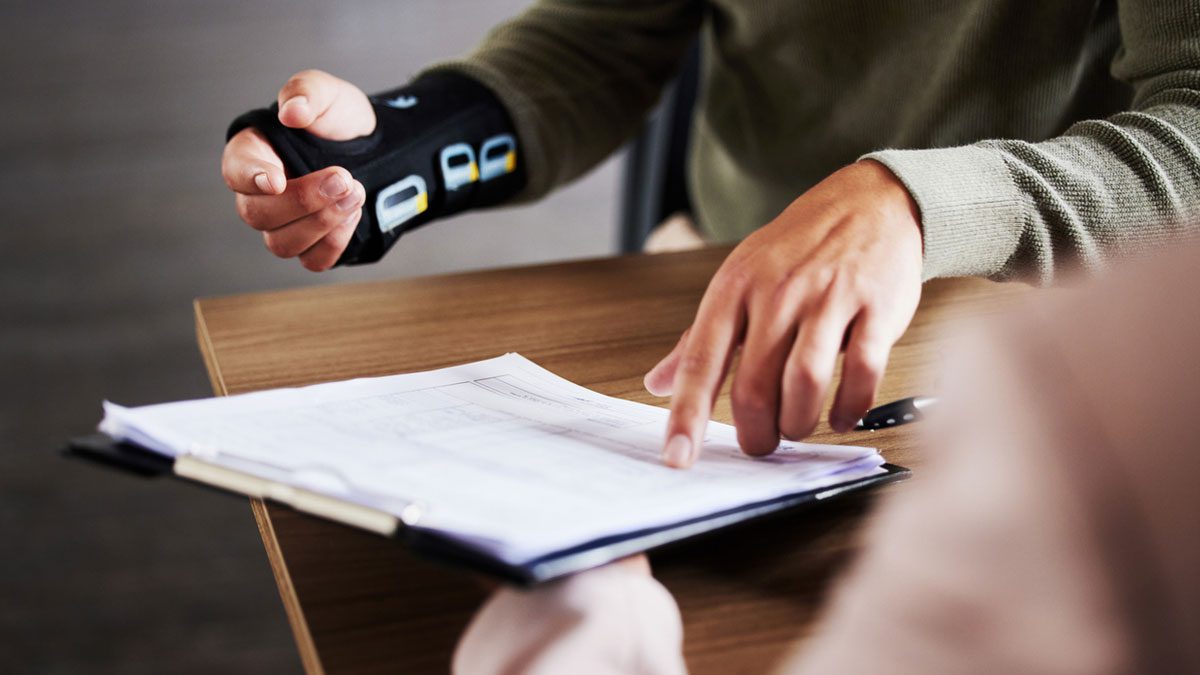 Male in a meeting with attorney for an advice on accident