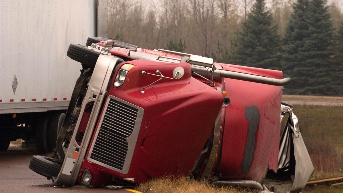 Truck crash with turned over semi