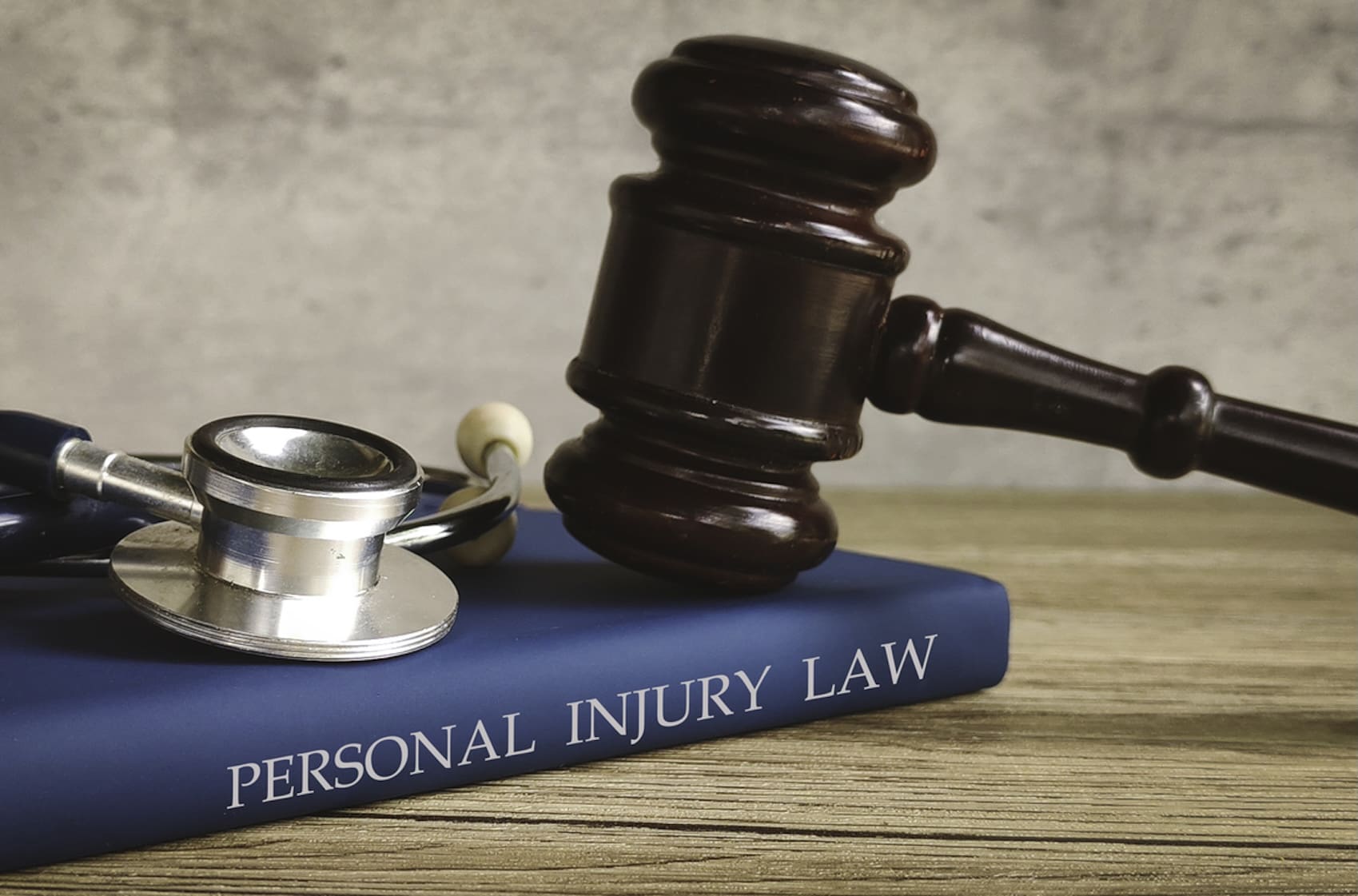 gavel and stethoscope on a book titled PERSONAL INJURY LAW, symbolizing legal action for medical issues