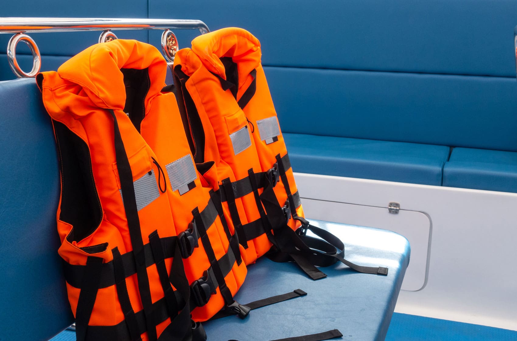 orange-life-jackets-stacked-on-a-boat-seat